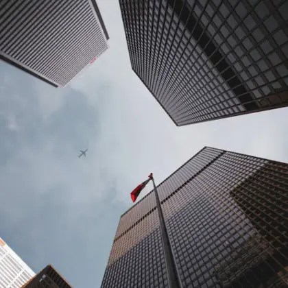 Plane flying above skyscrapers